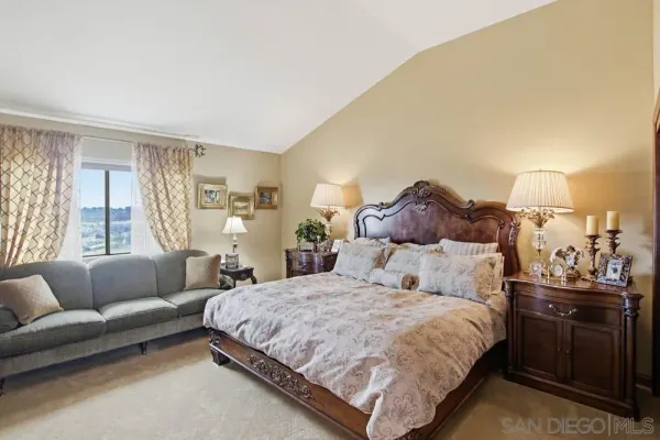 a bedroom with a bed and a couch