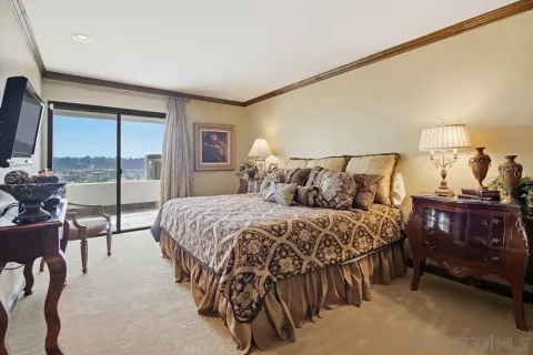 a bedroom with a bed and large window