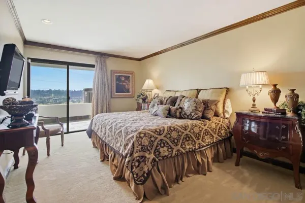 a bedroom with a bed and large window