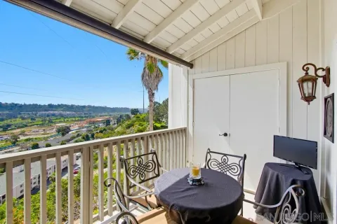 a view of a chair and table in the balcony