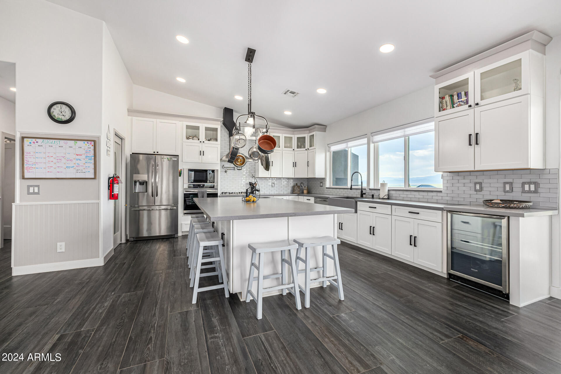 1829 West Cloud Road Phoenix, AZ 85086 - Photo 20 of 137 a kitchen with stainless steel appliances granite countertop a stove a refrigerator a sink dishwasher and a dining table with wooden floor