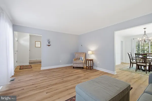 a living room with a wooden floor and furniture