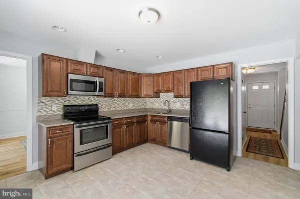 a kitchen with a refrigerator stove and microwave