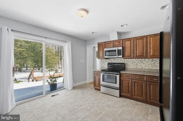 a kitchen with a stove a sink and a microwave