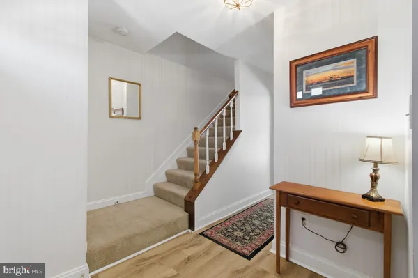 a view of staircase with wooden floor and a potted plant