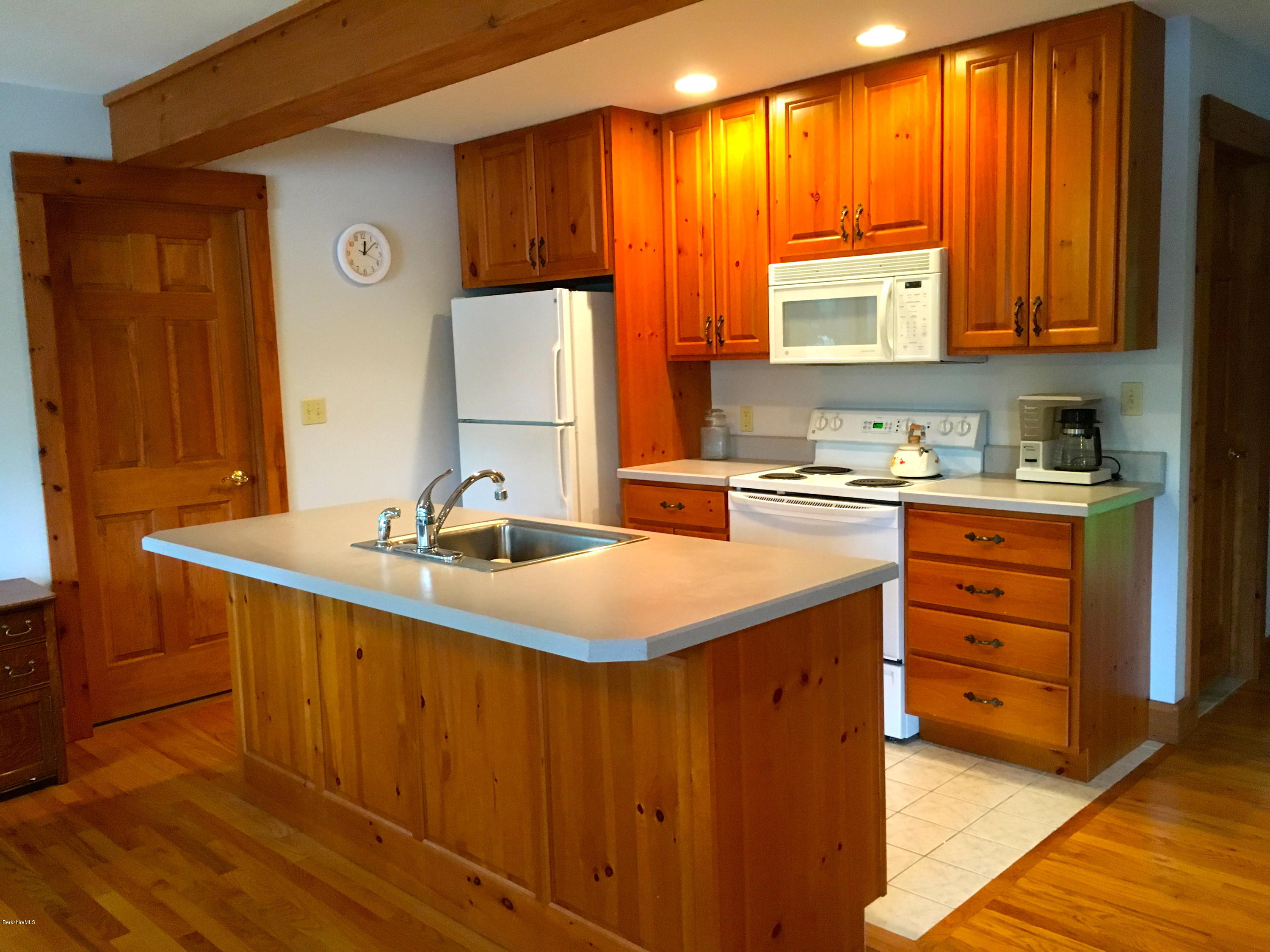 26 Bidwell Road Monterey, MA 01245 - Photo 5 of 17 a kitchen with a sink stove and cabinets