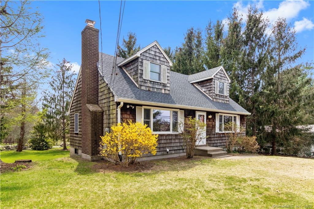 a view of a house with a yard patio and fire pit