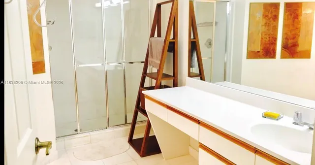 a bathroom with a sink and a shower