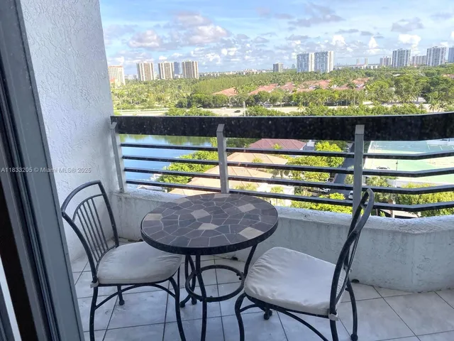a view of a chairs and table in a balcony