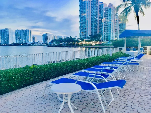 a view of a chairs and table in patio with a yard