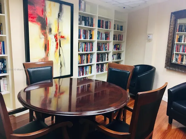 a view of a dining room with furniture and a book shelf