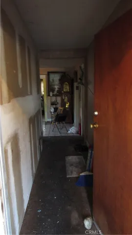 a view of a hallway with a wooden door