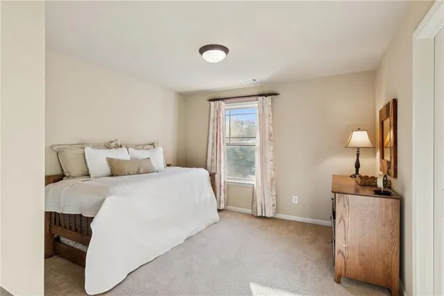 a spacious bedroom with a bed and a cabinets