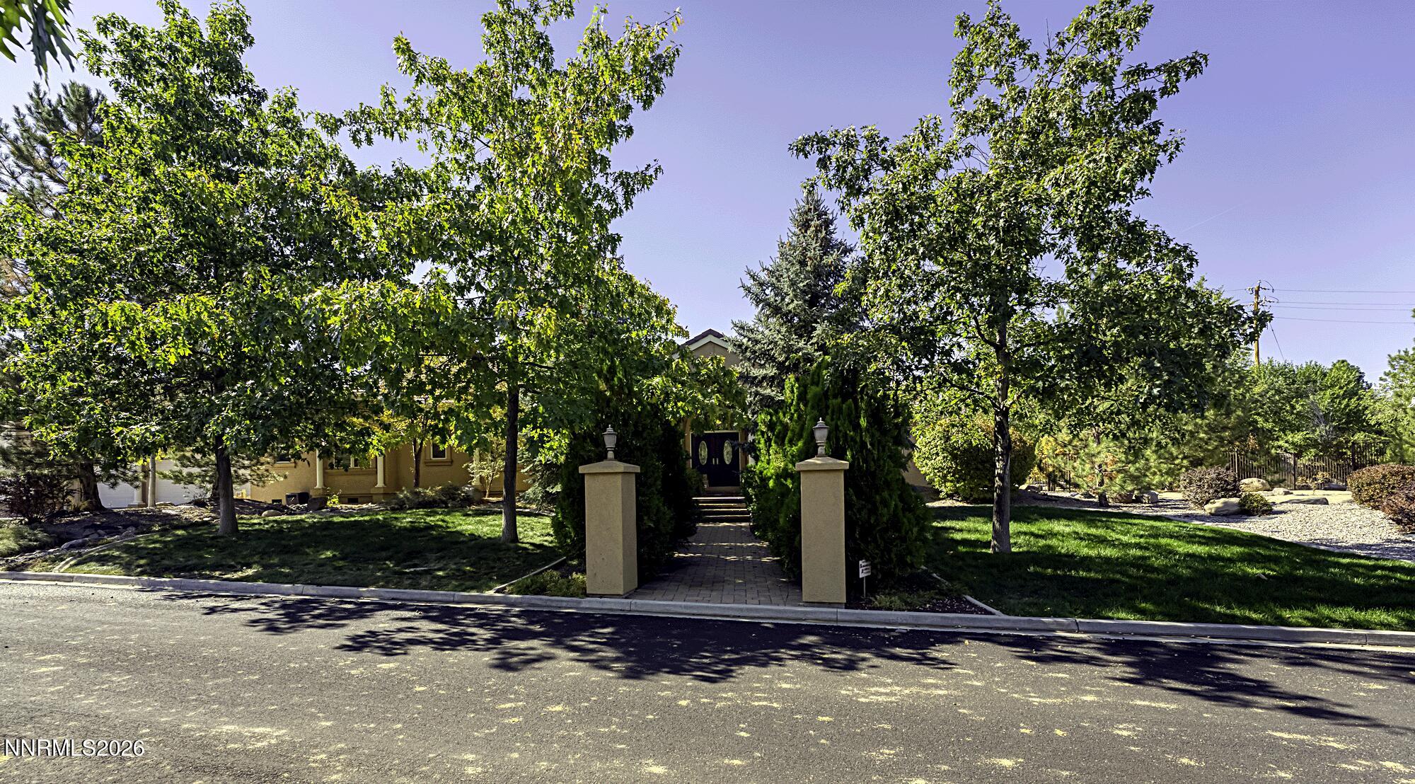 1120 Zolezzi Lane Reno, NV 89511 - Photo 2 of 48 a front view of a house with a yard and tree
