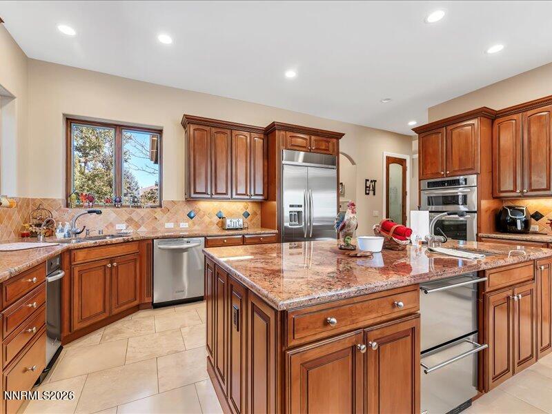 1120 Zolezzi Lane Reno, NV 89511 - Photo 23 of 48 a kitchen with stainless steel appliances granite countertop a sink stove and refrigerator