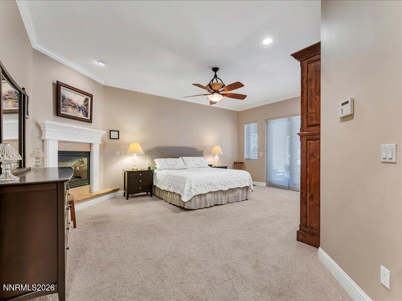 1120 Zolezzi Lane Reno, NV 89511 - Photo 24 of 48 a spacious bedroom with a bed and a fireplace