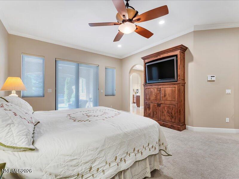1120 Zolezzi Lane Reno, NV 89511 - Photo 25 of 48 a bedroom with a large bed and a flat screen tv