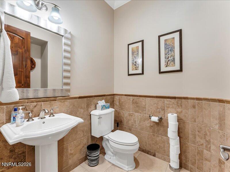 1120 Zolezzi Lane Reno, NV 89511 - Photo 36 of 48 a bathroom with a toilet sink and mirror