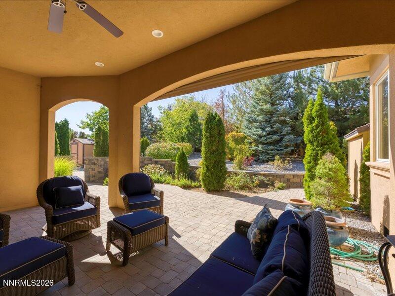1120 Zolezzi Lane Reno, NV 89511 - Photo 38 of 48 a living room with furniture and a floor to ceiling window