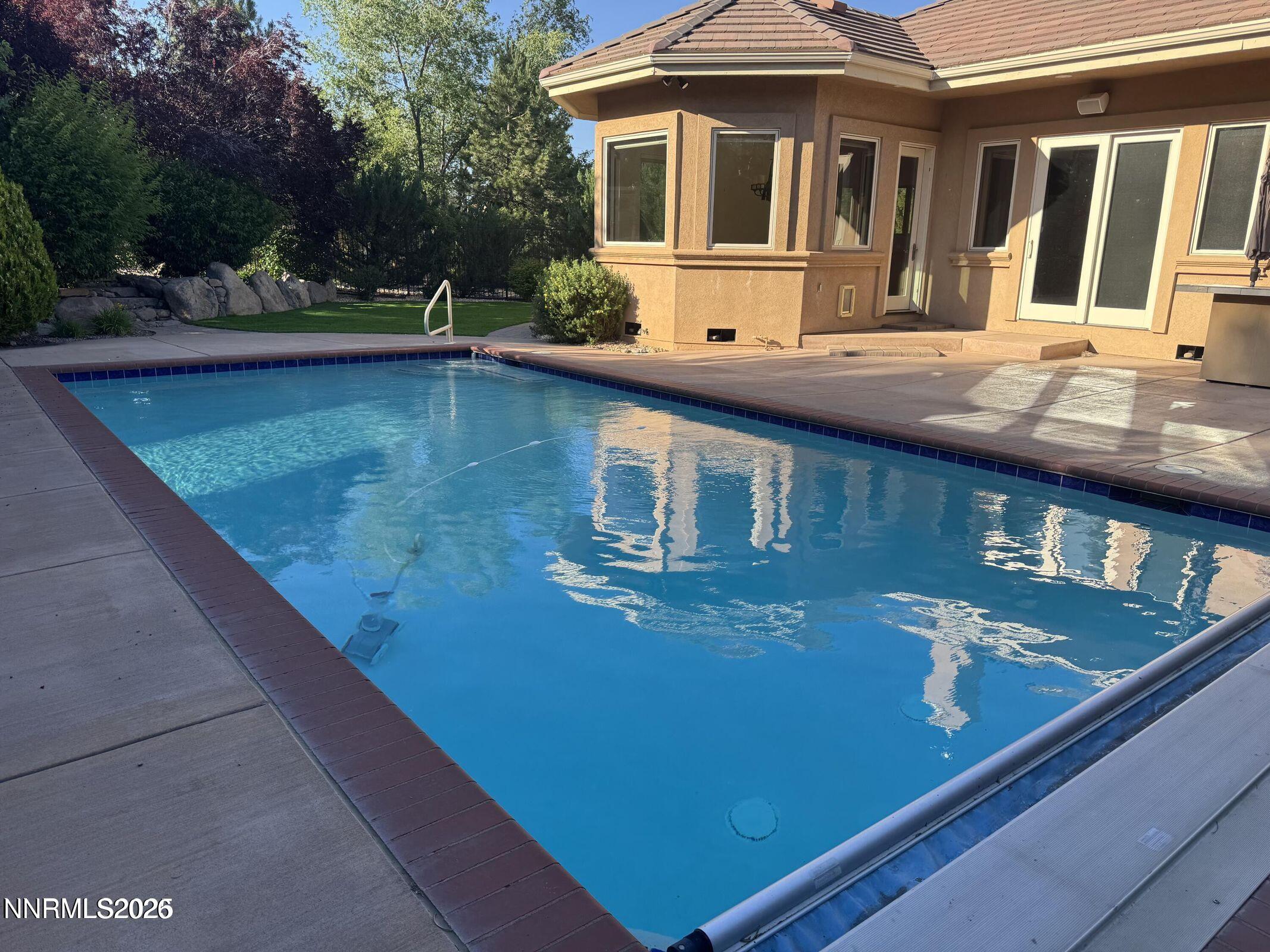 1120 Zolezzi Lane Reno, NV 89511 - Photo 39 of 48 a view of a house with pool and chairs