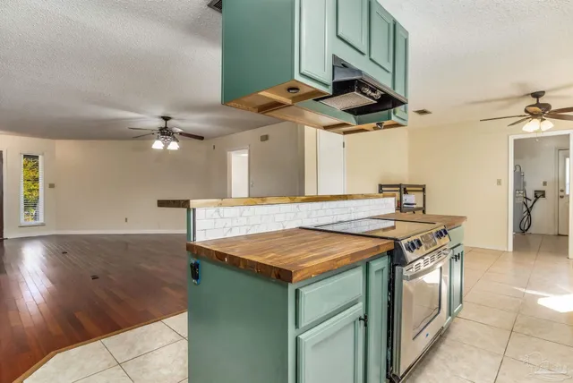 a view of kitchen with windows and ceiling fan