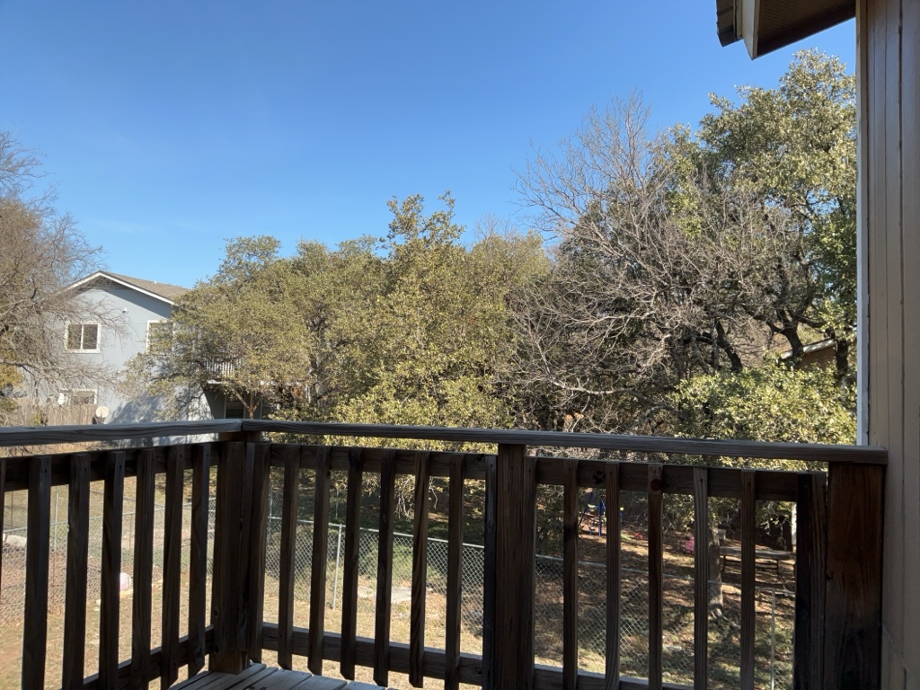 a balcony with wooden floor and fence