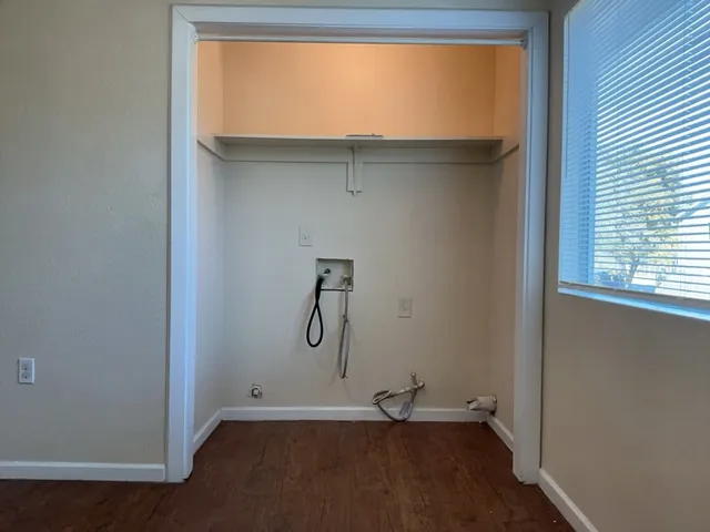 a view of a room with rack on the wall and a window