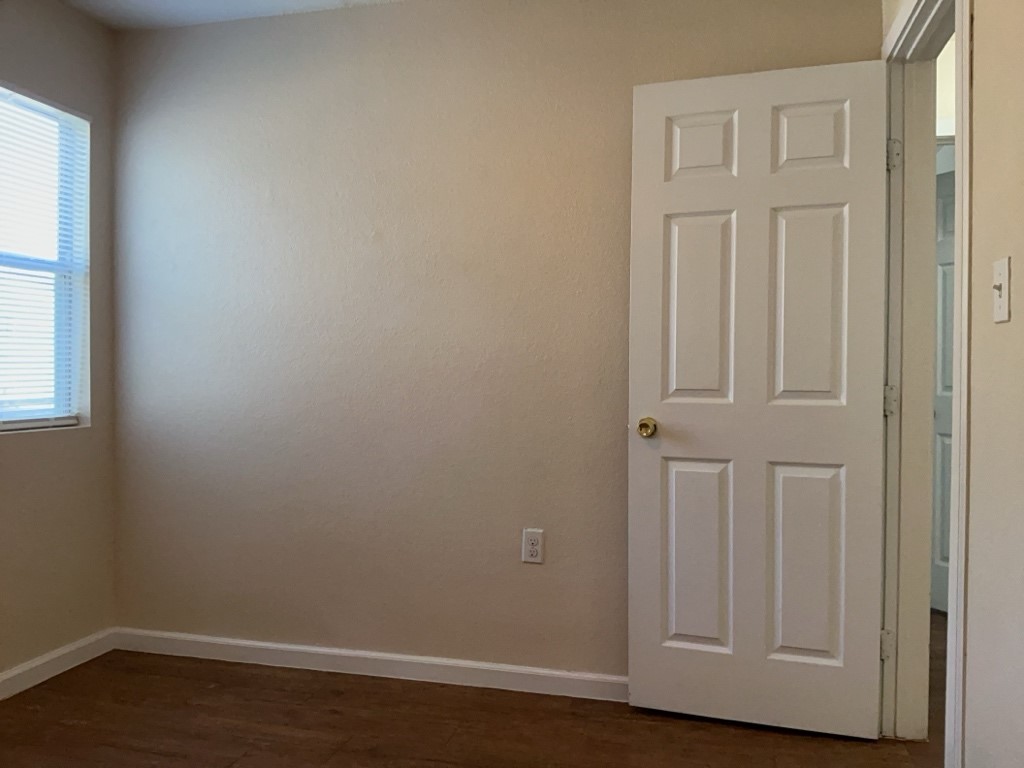 403 Hedgewood Drive, Unit D Georgetown, TX 78628 - Photo 12 of 12 an empty room with wooden floor closet and windows