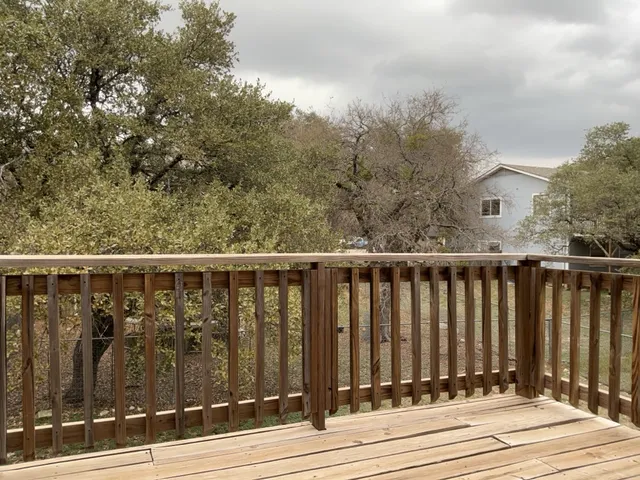 a view of a balcony with wooden fence