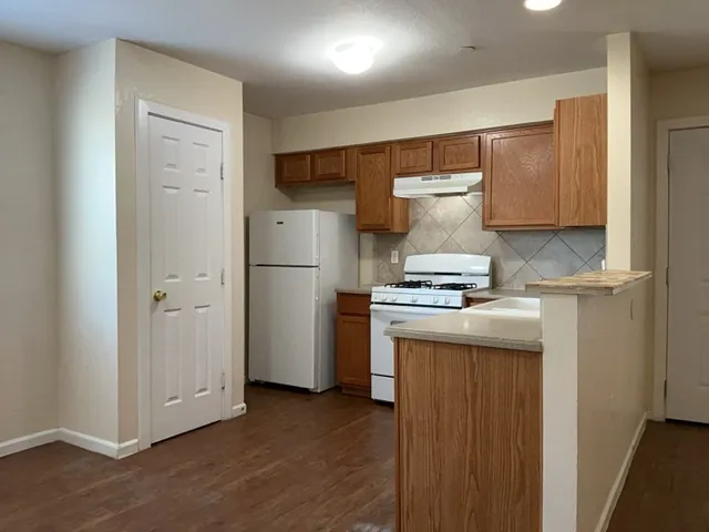 a kitchen with a refrigerator and a stove