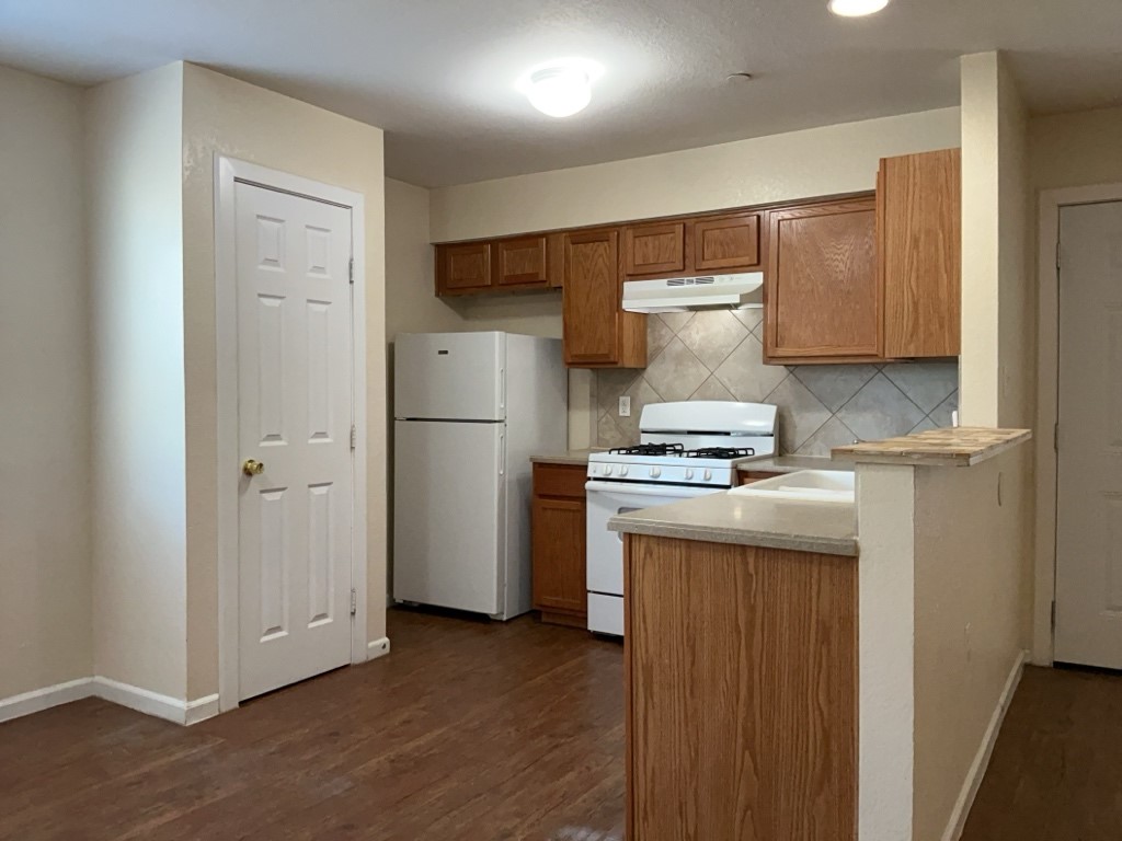 403 Hedgewood Drive, Unit D Georgetown, TX 78628 - Photo 6 of 12 a kitchen with a refrigerator and a stove