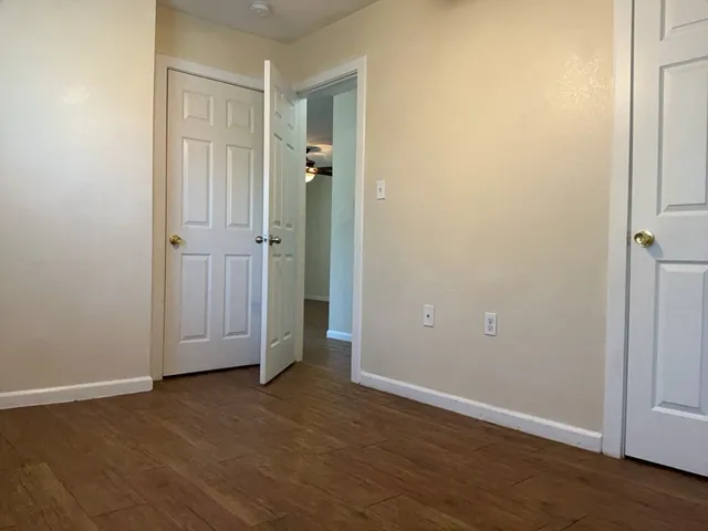 an empty room with wooden floor