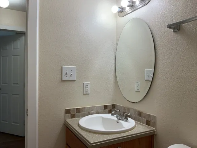 a bathroom with a sink and a mirror