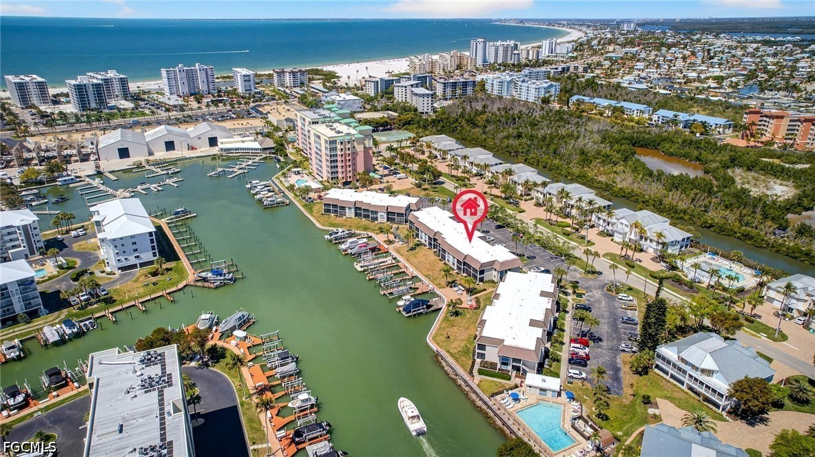 an aerial view of lake and residential houses with outdoor space
