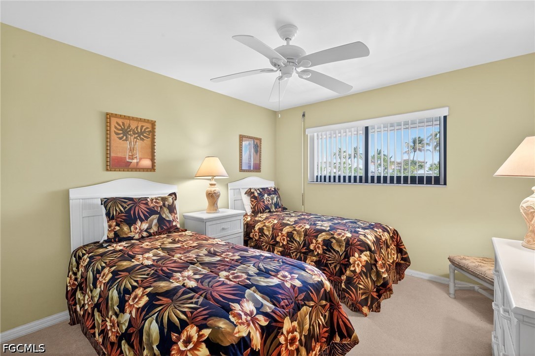200 Lenell Road, Unit 222 Fort Myers Beach, FL 33931 - Photo 13 of 33 a bedroom with two bed and a large mirror