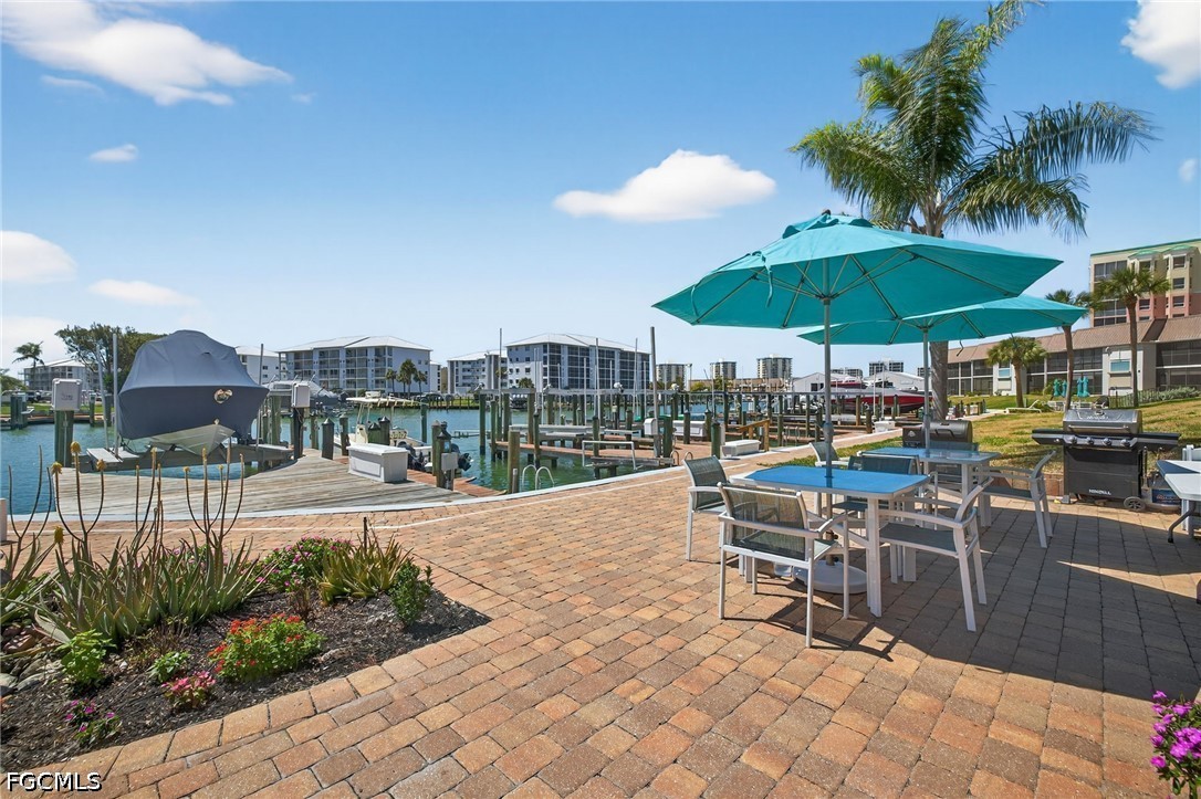 200 Lenell Road, Unit 222 Fort Myers Beach, FL 33931 - Photo 19 of 33 a view of a patio with chairs and umbrellas