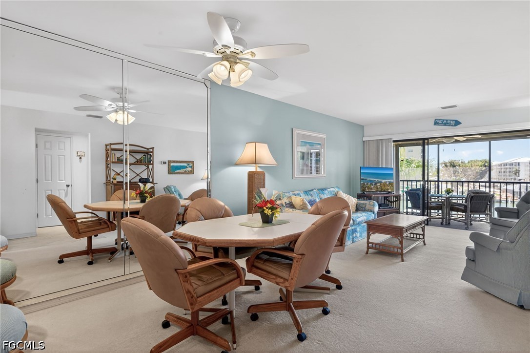 200 Lenell Road, Unit 222 Fort Myers Beach, FL 33931 - Photo 5 of 33 a dining room with furniture a livingroom view and a chandelier