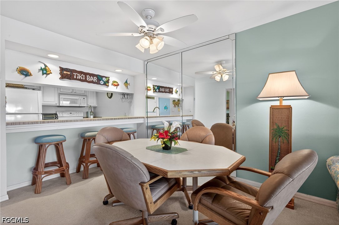 200 Lenell Road, Unit 222 Fort Myers Beach, FL 33931 - Photo 6 of 33 a view of a dining room with furniture and a chandelier fan
