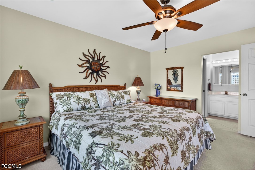 200 Lenell Road, Unit 222 Fort Myers Beach, FL 33931 - Photo 10 of 33 a bedroom with a large bed and a chandelier