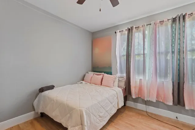 a bedroom with a bed and a window