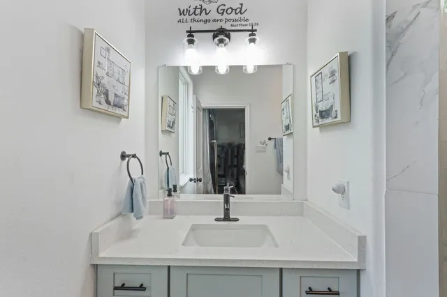 a bathroom with a sink and a mirror
