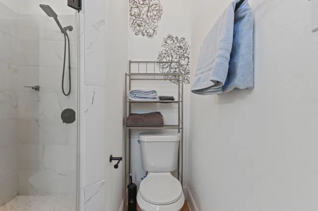 a bathroom with a toilet and a shower curtain