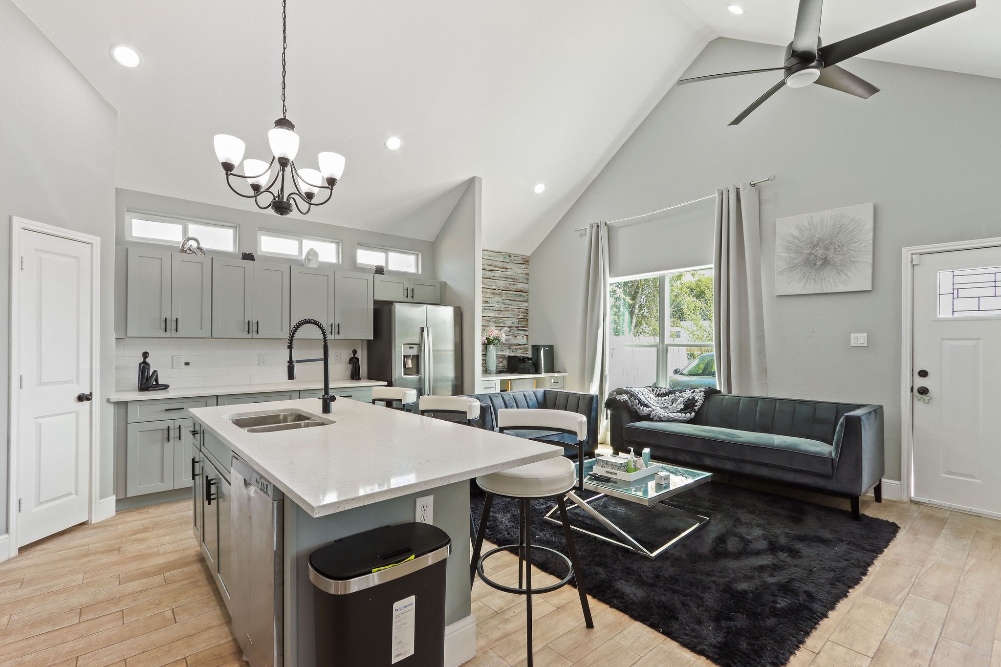 5607 Bacher Street, Unit B Houston, TX 77028 - Photo 5 of 22 a view of a dining room and livingroom with furniture wooden floor and a chandelier
