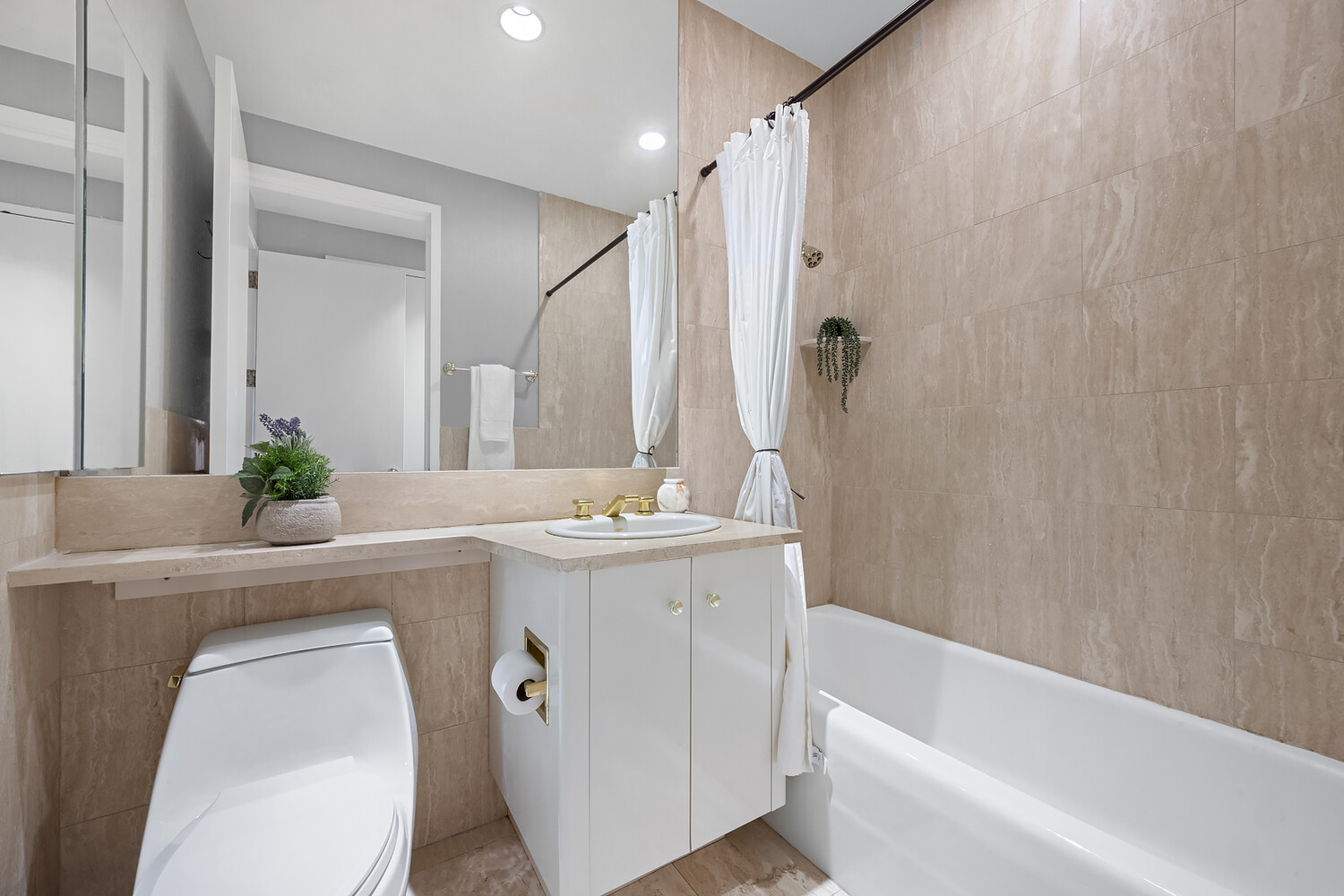 1 Central Park West, Unit 38C Manhattan, NY 10023 - Photo 10 of 24 a bathroom with a granite countertop sink a toilet and shower