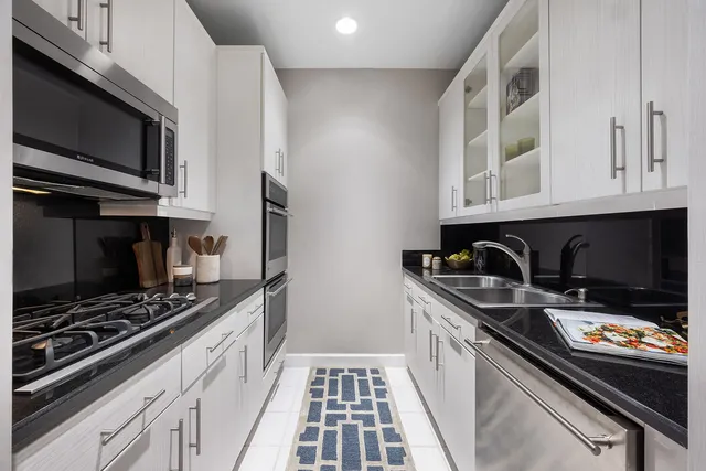 a bathroom with a sink toilet and mirror