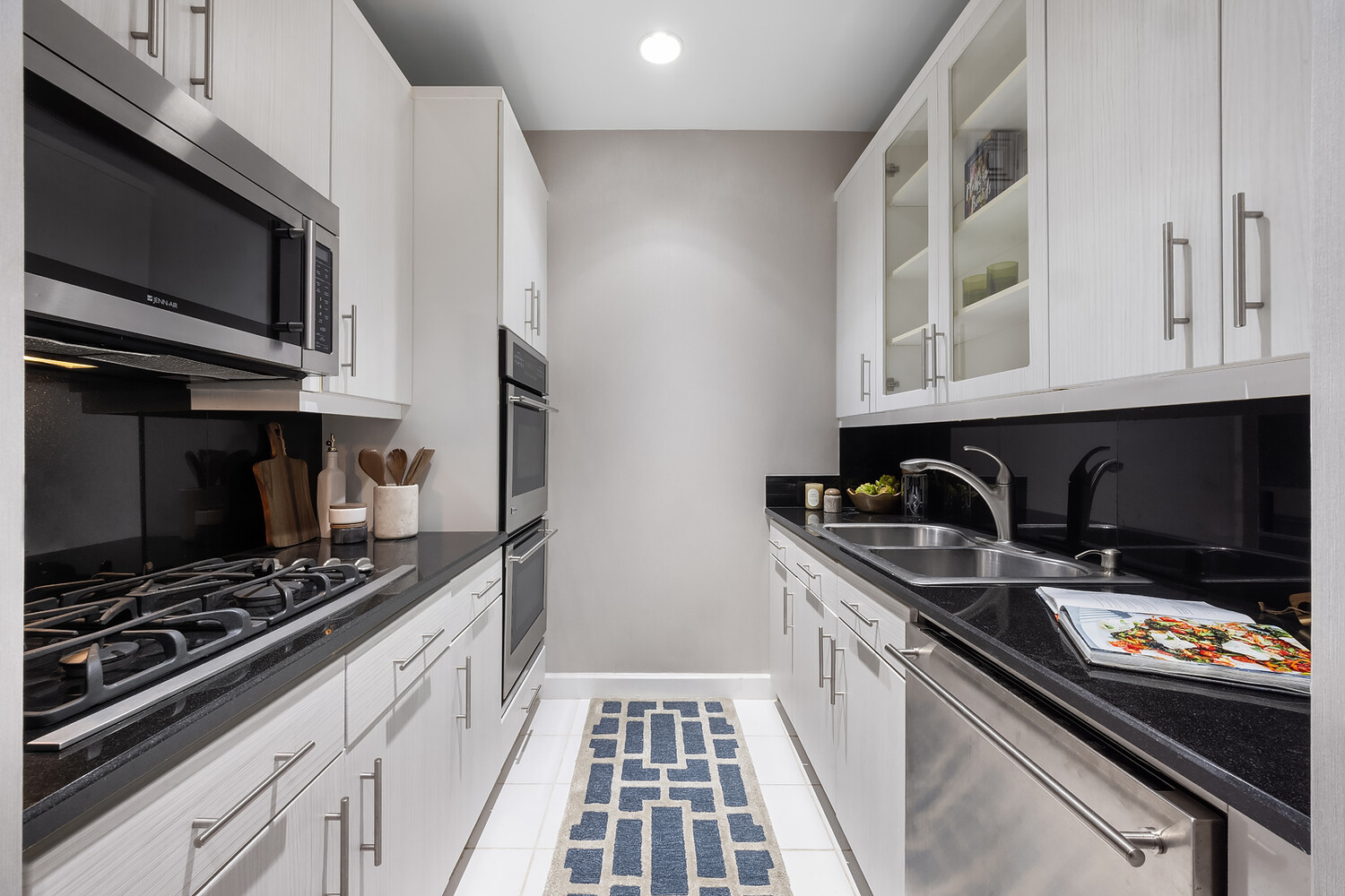 1 Central Park West, Unit 38C Manhattan, NY 10023 - Photo 12 of 24 a kitchen with a sink stove and microwave