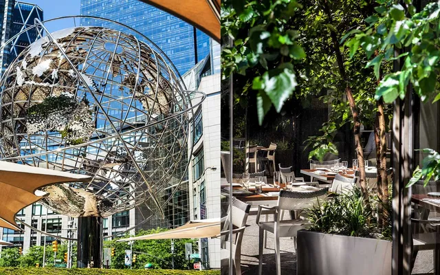 a view of a patio with table and chairs under an umbrella