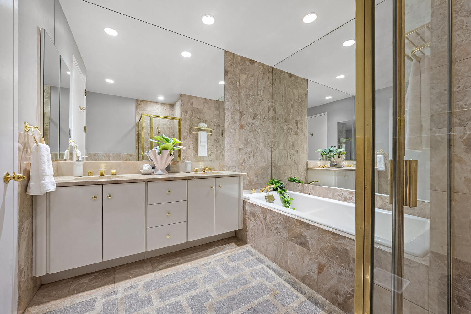 1 Central Park West, Unit 38C Manhattan, NY 10023 - Photo 8 of 24 a spacious bathroom with a granite countertop tub sink shower and mirror