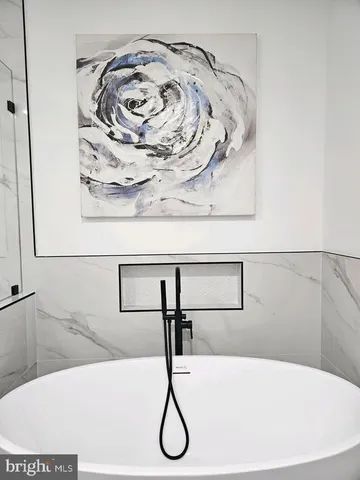 a bathroom with a bathtub and mirror