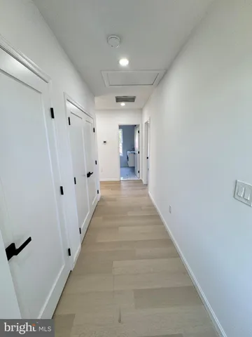 a view of a hallway with white walls